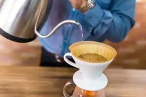 Make coffee pour-over by using steaming water and a filter basket.
