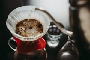 Using a filter dripper to make coffee pour-over style.