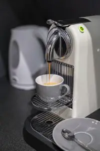 Brewing a cup of coffee with a Nespresso pod coffee maker