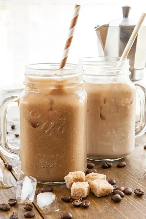 Iced coffee with milk in vintage jar