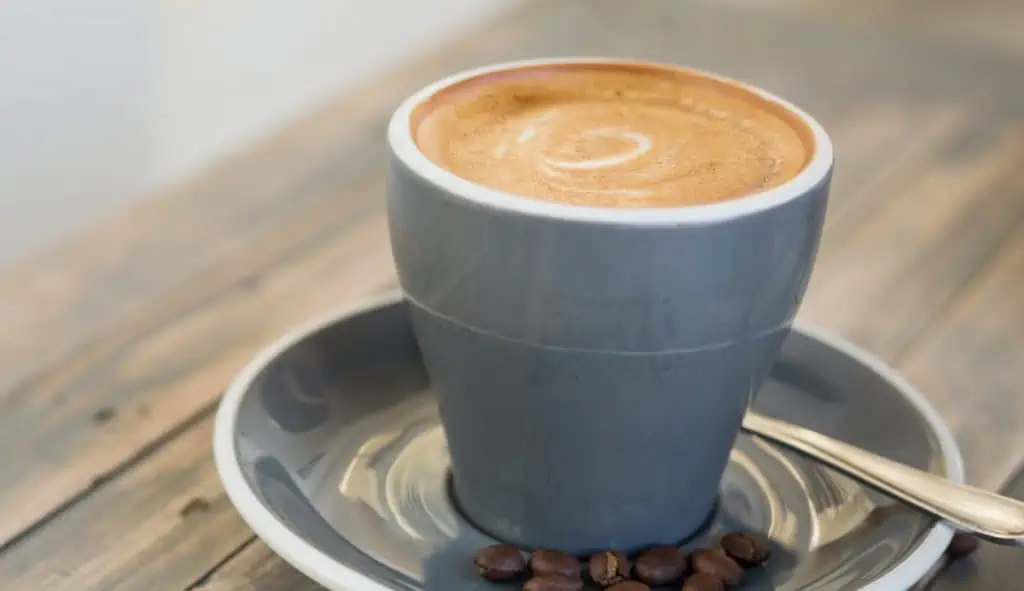Mug of flat white coffee with caffeine